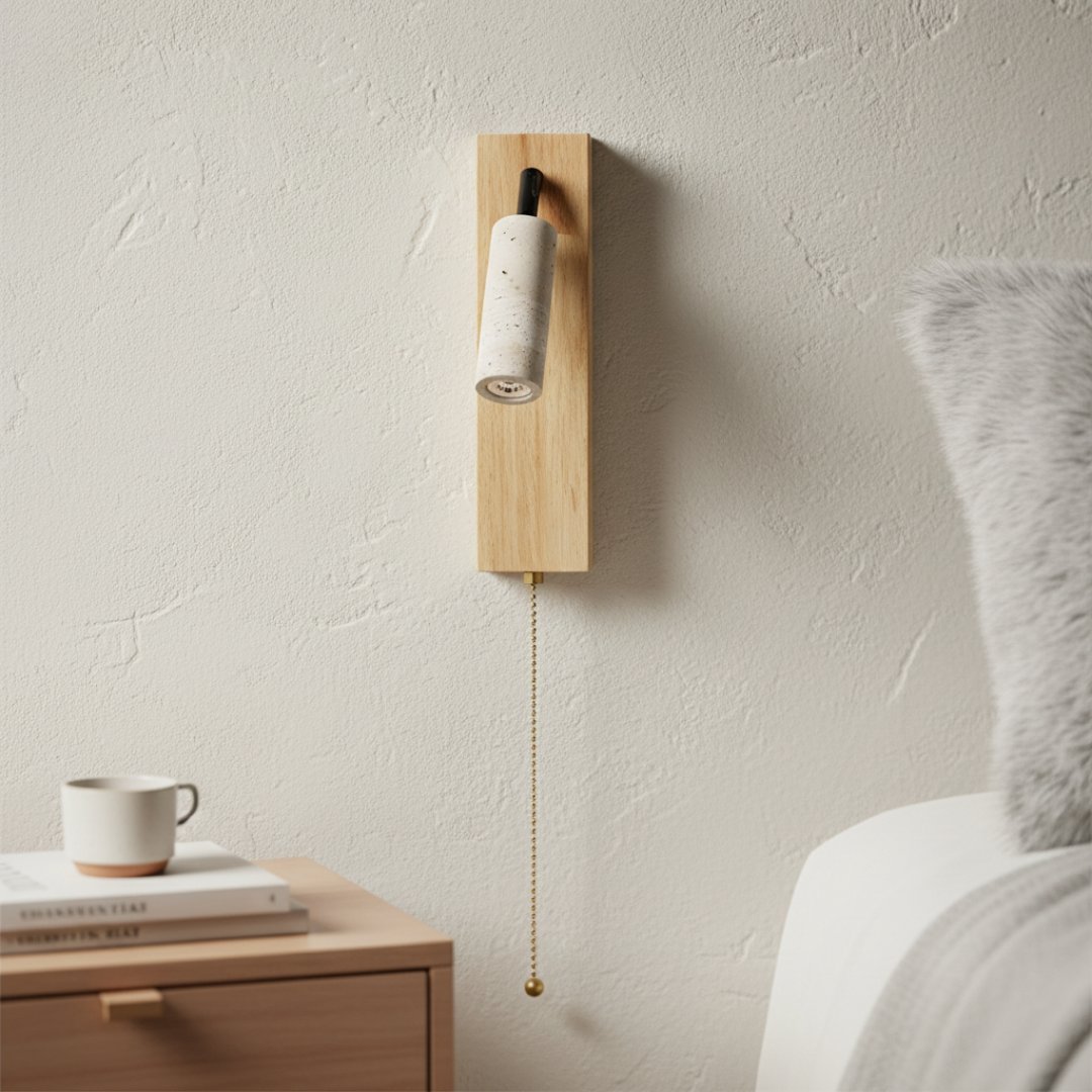 Swing arm wall lamp lighting a book beside a linen-covered bed
